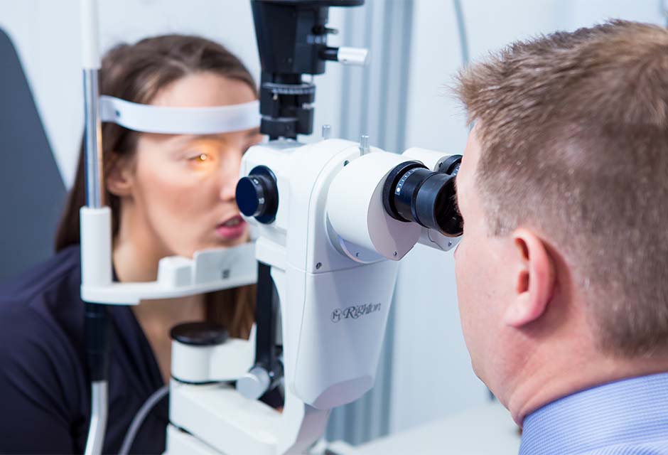 Heron Eyecare staff member checking eye health of customer
