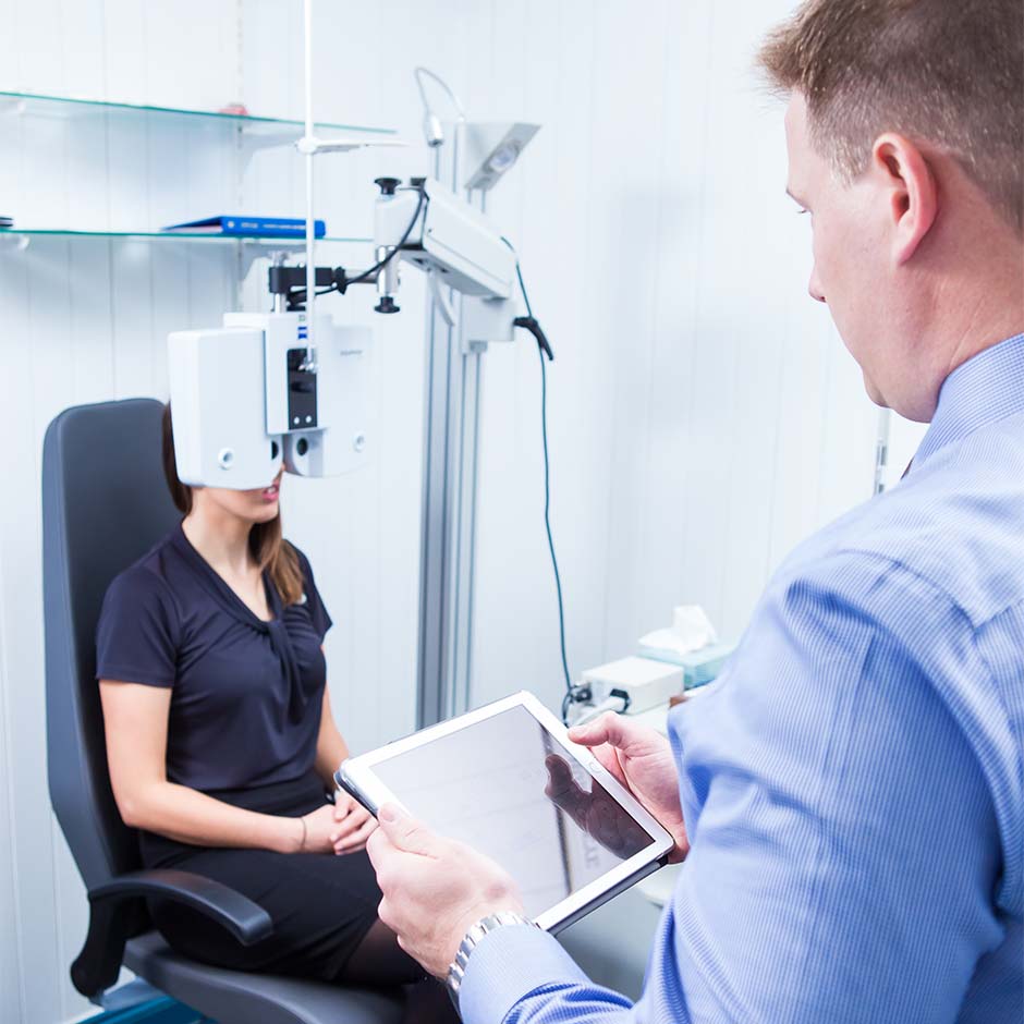 Heron Eyecare team member checking vision of patient