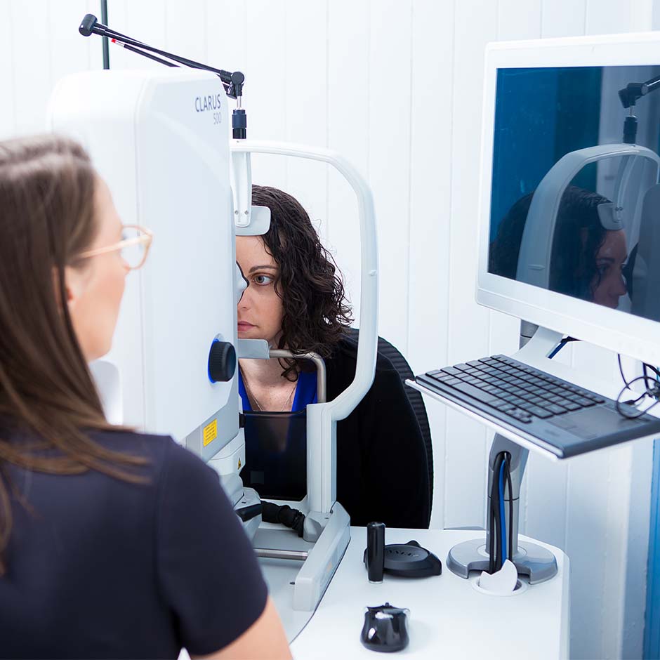 Heron Eyecare team member checking eye health using monitor