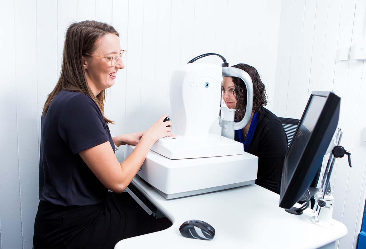 Heron Eyecare team member checking eye health of lady