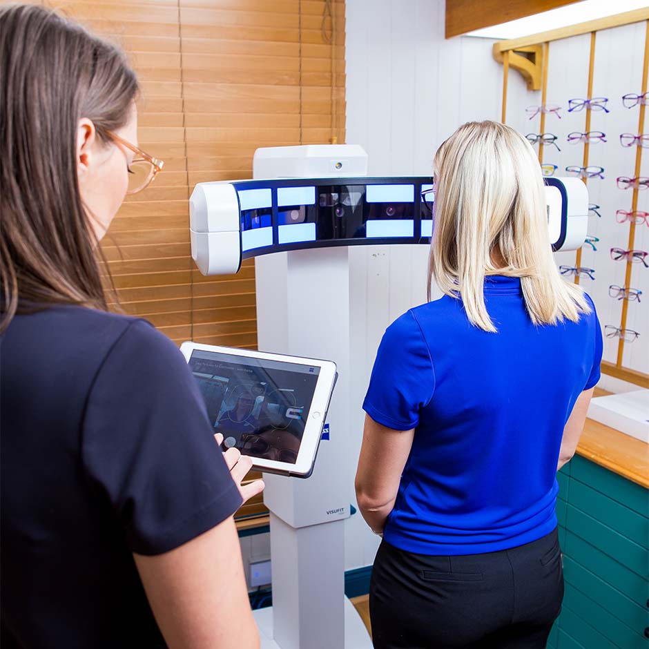 Heron Eyecare staff member helping lady select new glasses